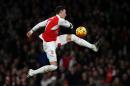 Arsenal's midfielder Mesut Ozil has a shot during the English Premier League football match between Arsenal and Bournemouth at the Emirates Stadium in London on December 28, 2015