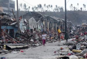 Residents walk past damaged structures caused by typhoon …