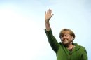 German Chancellor Angela Merkel waves at an election campaign event in Munich on September 20, 2013