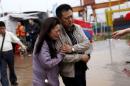Relatives of a missing passenger aboard a capsized ship cry on the banks of the Jianli section of Yangtze River in Hubei