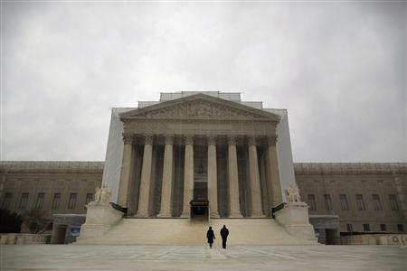 People walk in front of the Supreme Court building in Washington, March 24, 2013. REUTERS/Jonathan Ernst