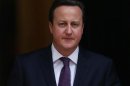 Britain's Prime Minister David Cameron walks out of 10 Downing Street to greet Qatar Emir Hamad bin Khalifa al-Thani in central London