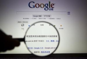 A person poses with a magnifying glass in front of a Google search page in this illustrative photograph taken in Shanghai