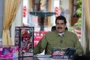 Venezuela's President Nicolas Maduro speaks next to children toys during his weekly broadcast "En contacto con Maduro" (In contact with Maduro) at Miraflores Palace in Caracas