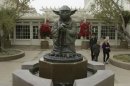 People walk past a fountain showing the Yoda character from the Star Wars movies outside of Lucasfilms headquarters in San Francisco, Tuesday, Oct. 30, 2012. The Walt Disney Co. announced Tuesday that it was buying Lucasfilm Ltd. for $4.05 billion. (AP Photo/Jeff Chiu)