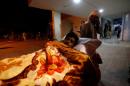 A police cadet injured during the attack on the Police Training Center is wheeled into a hospital in Quetta