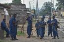 A photo taken on May 20, 2015 shows policemen holding a position in the Musaga neighborhood of Bujumbura during a demonstration against the Burundian President's third term