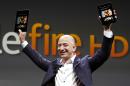 FILE - In this Sept. 6, 2012 file photo, Jeff Bezos, CEO and founder of Amazon, introduces the Amazon Kindle Fire during an event in Santa Monica, Calif. Amazon, the corporate juggernaut that started out with books and soon moved into music, video, cloud computing and Kindle e-readers, is hosting a launch event Wednesday, June 18, 2014 in Seattle, and media reports indicate the product will be an Amazon phone — perhaps one with multiple cameras that can produce 3-D photos. (AP Photo/Reed Saxon, File)