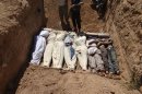 FILE - This image provided by by Shaam News Network on Thursday, Aug. 22, 2013, which has been authenticated based on its contents and other AP reporting, purports to show several bodies being buried in a suburb of Damascus, Syria during a funeral on Wednesday, Aug. 21, 2013. The early-morning barrage against rebel-held areas around the the Syrian capital Damascus immediately seemed different: The rockets made a strange, whistling noise. Seconds after one hit near his home, Qusai Zakarya says he couldn't breathe, and he desperately punched himself in the chest to get air. Hundreds of suffocating, twitching victims flooded into hospitals. Others were later found dead in their homes, towels still on their faces from their last moments trying to protect themselves from gas. Doctors and survivors recount scenes of horror from the alleged chemical attack a week ago. (AP Photo/Shaam News Network, File)