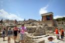 Tourists visit the Minoan Knossos Palace on Crete island on July 26, 2010 in Greece