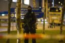 A Dutch policeman stands guard by a cordoned off area outside Amsterdam's Schiphol Airport late on April 12, 2016