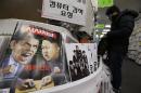 A magazine with cartoons of U.S. President Barack Obama, left, and North Korean leader Kim Jong Un is displayed at a book store in Seoul, South Korea, Saturday, Jan. 3, 2015. The United States imposed new sanctions Friday on North Korean government officials and the country's defense industry for a cyberattack against Sony, insisting that Pyongyang was to blame despite lingering doubts by the cyber community. The red letters on the magazine read " Hacker War." (AP Photo/Ahn Young-joon)