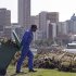 A worker pulls a refuse bin as he and others clean up the beach area in Durban, South Africa, Tuesday, Nov 29, 2011. The U.N. weather office says world temperatures maintained a long-term upward trend and Arctic sea ice shrank to record low volumes this year. The report by the International Meteorological Organization, released in Geneva and at the U.N. climate talks Tuesday, provided a bleak backdrop to negotiators seeking ways to limit pollution blamed for global warming. (AP Photo/Schalk van Zuydam)