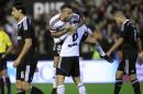 Valencia's Nicolas Otamendi, from Argentina, top center, celebrates his victory at the end a Spanish La Liga soccer match against Real Madrid at the Mestalla stadium in Valencia, Spain, on Sunday, Jan. 4, 2015. Valencia won the match 2-1. (AP Photo/Alberto Saiz) is greeted by teammates