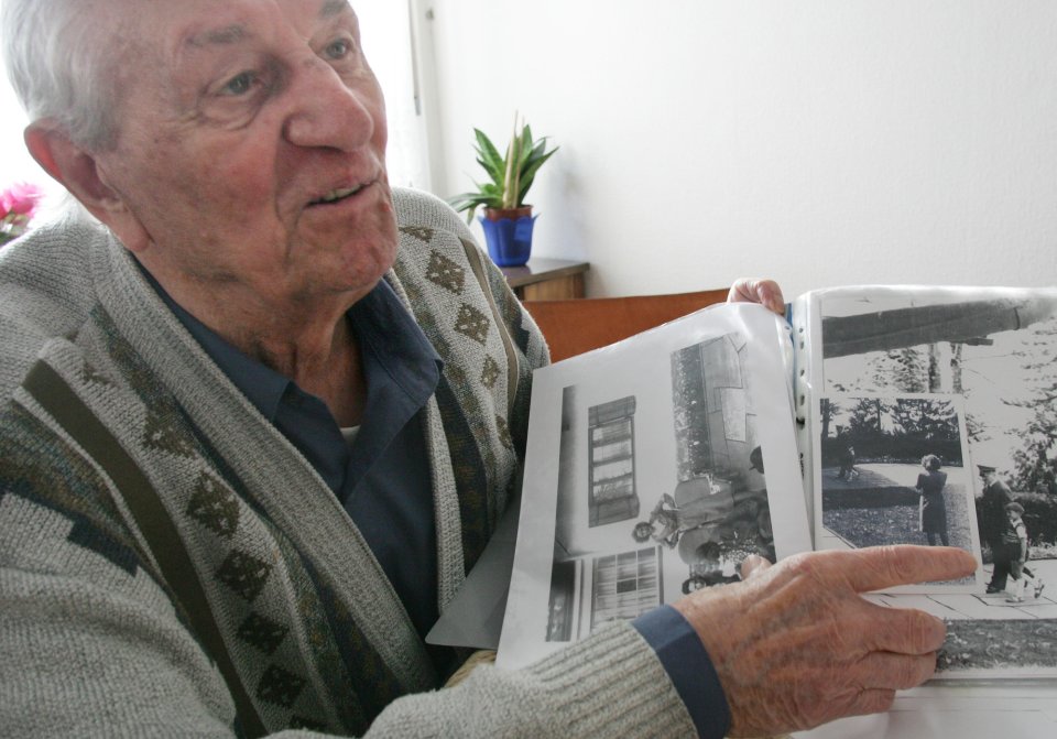 FILE - In this March 10, 2005 file photo Hitler's bodyguard Rochus Misch points on a picture of Adolf Hitler he had taken in Berchtesgarden, southern Germany, in the early 1940th in his house in Berlin. Misch, who was the last remaining witness to the Nazi leader's final hours in his Berlin bunker, has died Thursday, Sept. 5, 2013. He was 96. (AP Photo/Herbert Knosowski, File)