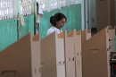 A woman mark her ballot during the presidential election in Santo Domingo, Dominican Republic, Sunday May 20, 2012. (AP Photo/Manuel Diaz)