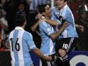 Lionel Messi celebrates with Sergio Aguero and Angel di Maria after scoring against Uruguay during their 2014 World Cup qualifying soccer match in Mendonza