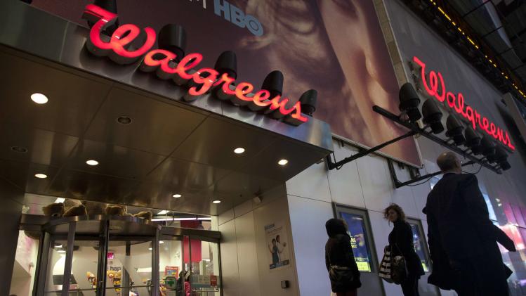 Shoppers walk by at the Walgreens' Times Square store in New York in this file photo