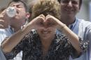 Brazil's President and Workers Party candidate Dilma Rousseff flashes a heart hand gesture during a rally for her re-election campaign in Rio de Janeiro, Brazil, Monday, Oct. 20, 2014. Rousseff and her challenger Aecio Neves of the Brazilian Social Democracy Party are in a tight election contest, that culminates Oct. 26 when upward of 140 million Brazilians are expected to go to the polls and decide who'll be the next leader of the globe's fifth most populous nation and Latin America's biggest economy. (AP Photo/Silvia Izquierdo)