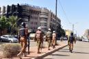 Burkina Faso troops patrol outside the Splendid Hotel and nearby Cappuccino restaurant following a jihadist attack in Ouagadougou on January 16, 2016