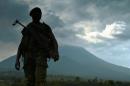 A soldier from the Democratic Republic of Congo regular army stands guard in Kibati, with the Nyiragongo Volcano in the background, on September 4, 2013