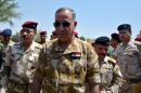 Iraqi Defence Minister Khaled al-Obeidi walks during his visit to the Nineveh Liberation Operations Command at Makhmour base, south of Mosul