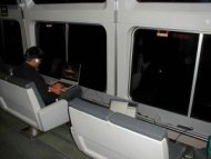 Man using laptop on a train
