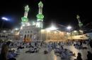 Muslim piligrims wait to perform morning prayer in Mecca's Grand Mosque, on October 13, 2013