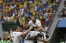 France's Karim Benzema, top, celebrates with teammates including Paul Pogba, bottom right, after Pogba scored their side's first goal during the World Cup round of 16 soccer match between France and Nigeria at the Estadio Nacional in Brasilia, Brazil, Monday, June 30, 2014. France won 2-0 to reach the World Cup quarterfinals. (AP Photo/Ricardo Mazalan)