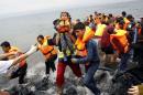 Syrian refugees frantically run off an overcrowded dinghy moments after arriving on the Greek island of Lesbos
