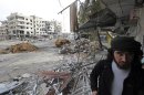 A Free Syrian Army fighter walks in the Haresta neighbourhood of Damascus