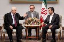 Iranian President Mahmoud Ahmadinejad (R) meets with Syrian Foreign Minister Walid al-Muallem (L) in Tehran