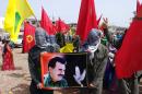 Masked Kurdish people hold a portait of jailed Kurdish rebel chief Abdullah Ocalan during a 2013 ceremony in Urfa, southeastern Turkey
