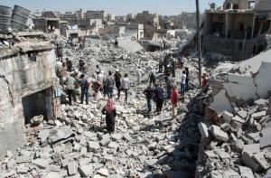 Syrians stand on the rubble of buildings after a missile &hellip;
