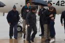 A photo released by Presidencia del Gobierno, taken on May 8, 2016, shows Spanish journalists Angel Sastre (3L), Jose Manuel Lopez (2L) and Antonio Pampliega (R) at Torrejon military airport in Madrid
