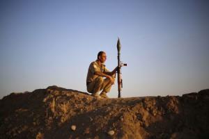 File photo of a Kurdish Peshmerga fighter keeping guard &hellip;