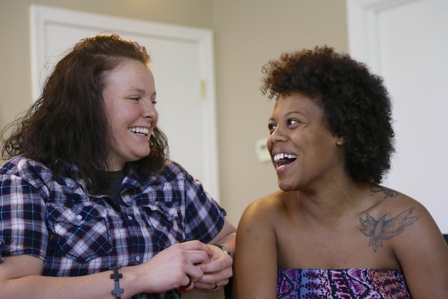 Danielle Powell, right, and her spouse Michelle Rogers are photographed in Omaha, Neb., Wednesday, June 12, 2013. Grace University, a Christian college in Omaha, has revoked Powell's scholarship and expelled her because she was public about a same-sex relationship. The college also is demanding payment of tuition and won't send her transcripts to other schools until she pays off her bill. (AP Photo/Nati Harnik)