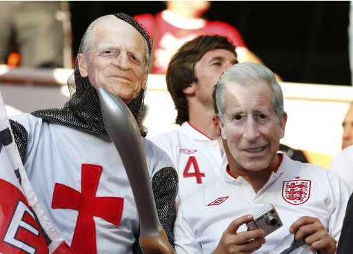 England's fans wear Prince Charles and Prince Philipp masks as they cheer before Group D  Euro 2012 soccer match against France at Donbass Arena in Donetsk