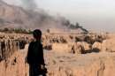 An Afghan girl looks over a ravine toward smoke rising from a brick factory chimney in Surkh Rod district, Jalalabad east of Kabul, Afghanistan, Tuesday, Oct. 30, 2012. (AP Photo/Rahmat Gul)