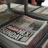 Copies of The Sun newspaper are seen for sale at a newsstand in London