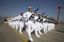 New recruits of the Chinese Navy march with guns during the parade marking the end of their first training session in Qingdao