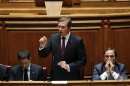 Portugal's PM Coelho speaks as he is flanked by Finance Minister Gaspar and Foreign Affairs Minister Portas during a debate in parliament in Lisbon