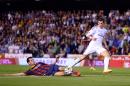 Real's Gareth Bale, right, looses the ball to Barcelona's Sergio Busquets during the final of the Copa del Rey between FC Barcelona and Real Madrid at the Mestalla stadium in Valencia, Spain, Wednesday, April 16, 2014. (AP Photo/Manu Fernandez)