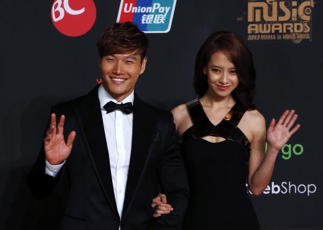 South Korean singer Kim and actress Song wave on the red carpet during Asian Music Awards in Hong Kong