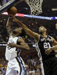 Memphis Grizzlies guard Tony Allen (9) drives to the basket as San Antonio Spurs forward Tim Duncan (21) reaches for the ball during the first half of Game 3 in their NBA basketball Western Conference finals playoff series, Saturday, May 25, 2013, in Memphis, Tenn. (AP Photo/Danny Johnson)