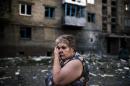 A woman reacts after shelling in the town of Yasynuvata near the rebel stronghold of Donetsk on August 12, 2014