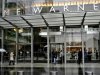 People walk in front of the Time Warner Inc. headquarters building at Columbus Circle in New York
