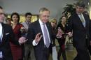 Senate Majority Leader Harry Reid of Nev., center, is pursued by reporters on Capitol Hill in Washington, Wednesday, Dec. 11, 2013, following a closed-door briefing on the recent agreement reached between Iran and western powers on Iran's nuclear program. (AP Photo/Susan Walsh)