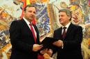 Macedonian President Gjorge Ivanov (R) hands a mandate for forming a new government to interim premier Emil Dimitriev on January 18, 2016 in Skopje
