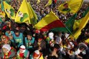 Demonstrators hold Kurdish flags and portraits of jailed Kurdistan Workers Party (PKK) leader Abdullah Ocalan during a gathering to celebrate Newroz in the southeastern Turkish city of Diyarbakir
